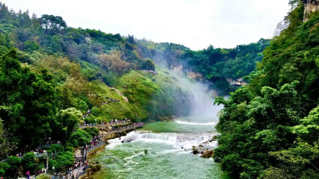 A beautiful wide view of Ban Gioc Waterfall with green trees