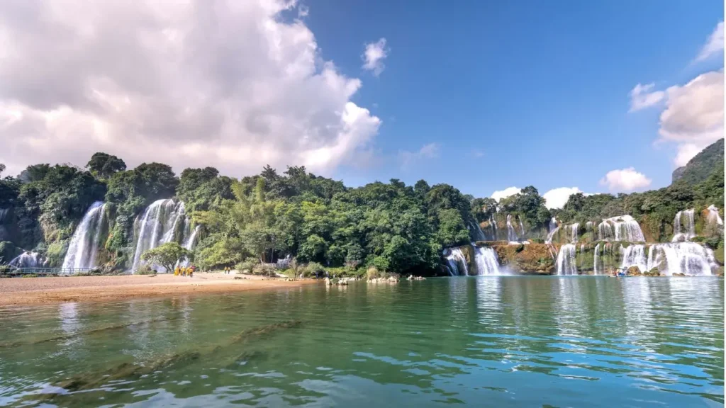 A beautiful wide view of Ban Gioc Waterfall with green trees
