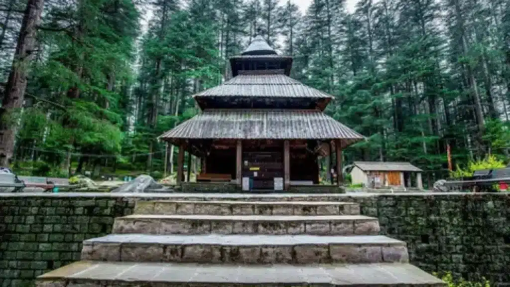 The ancient wooden Hadimba Devi Temple surrounded by tall cedar forests in Manali.