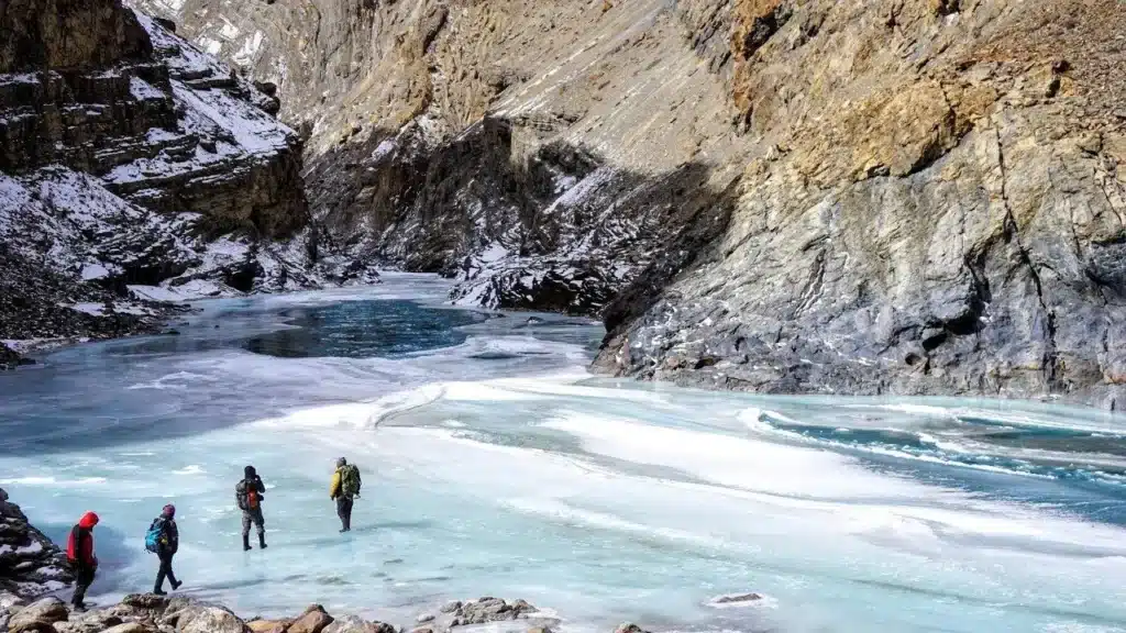 A wide scenic view of snow-capped Himalayan mountains and Beas River in Manali.