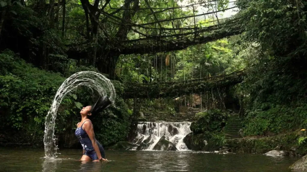 The magnificent Double Decker Living Root Bridge, made from the roots of rubber trees, crossing a rushing river in the deep valleys of Meghalaya near Cherrapunji