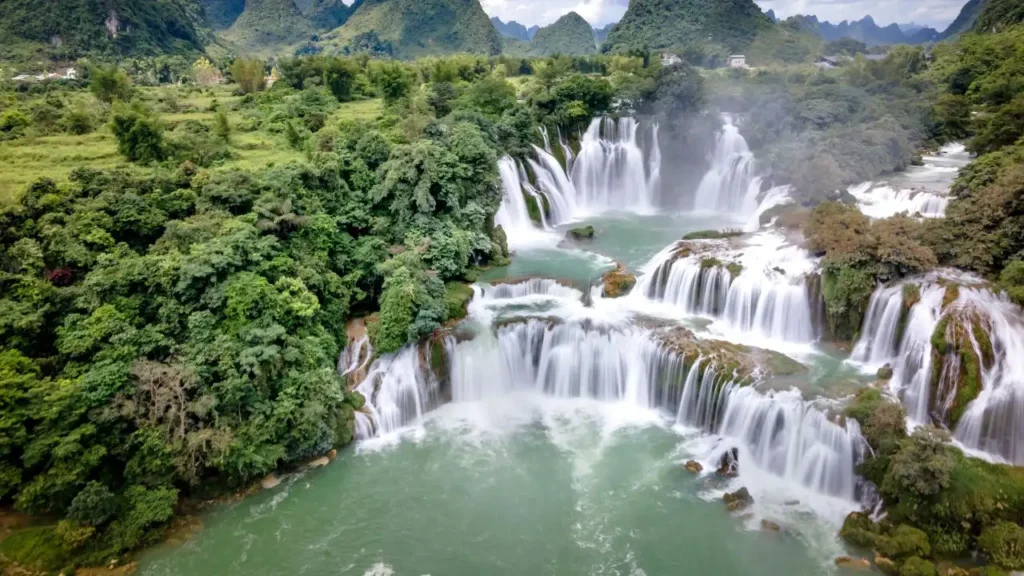 A beautiful wide view of Ban Gioc Waterfall with green trees