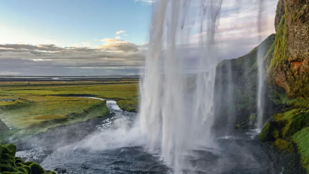 The view from inside the cave looking out through the water flow of Seljalandsfoss waterfall