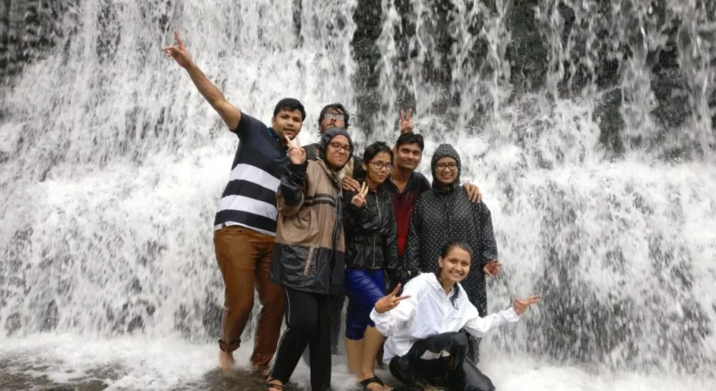 A happy family enjoying their trip to the beautiful Mulshi waterfalls.