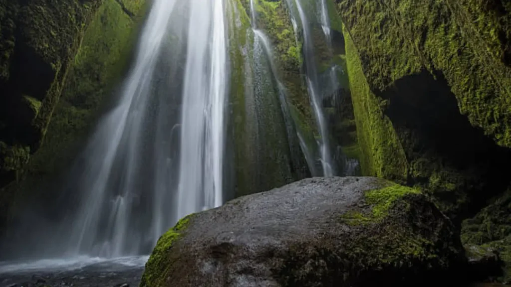 A breathtaking view inside the canyon of Gljúfrabúi waterfall with green mossy walls