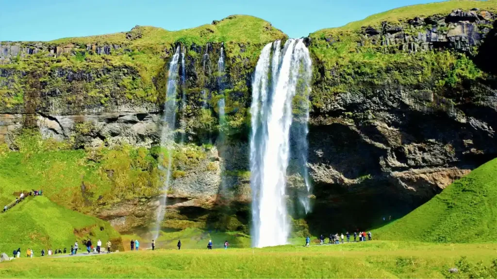 A tall vertical view showing the 60-meter height of Seljalandsfoss waterfall